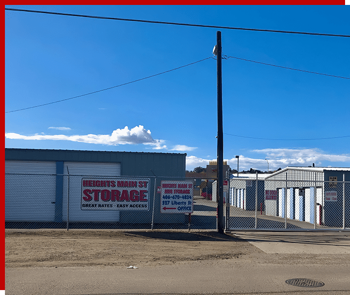 A large empty lot with storage buildings and telephone poles.