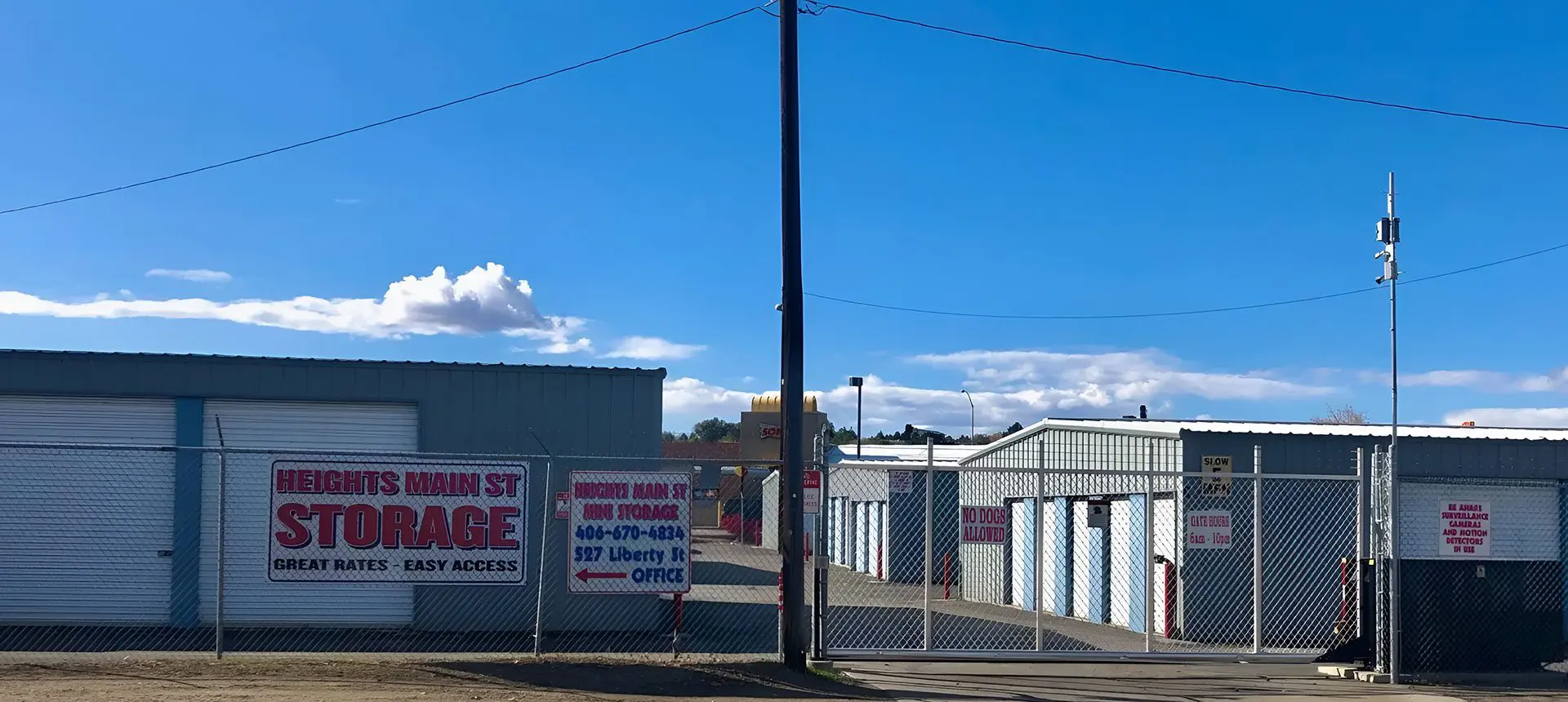 A row of storage units with signs on them.