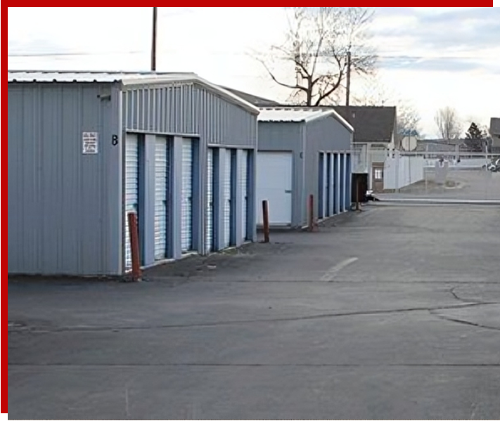 A row of storage units in an empty lot.